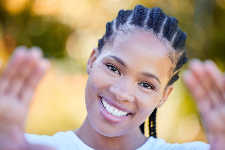 Smiling woman with braided hair. Wisdom teeth removal for teens